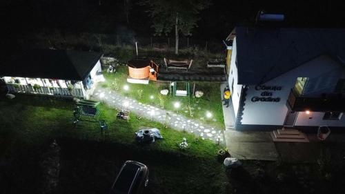 einen Blick über den Hof in der Nacht mit Lichtern in der Unterkunft Casuta din Gradina in Horezu