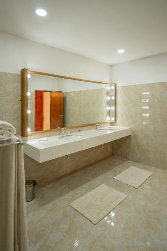 a bathroom with a sink and a large mirror at Samsara in Galle
