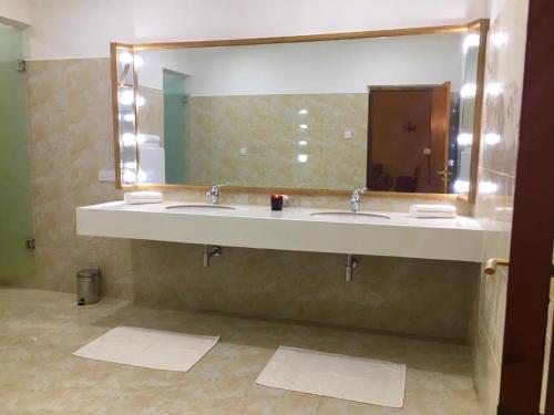 a bathroom with two sinks and a large mirror at Samsara in Galle