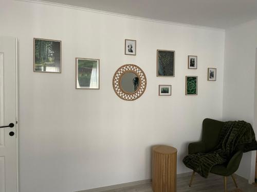 a room with a chair and a mirror on a wall at Carol Apartament's in Timişoara