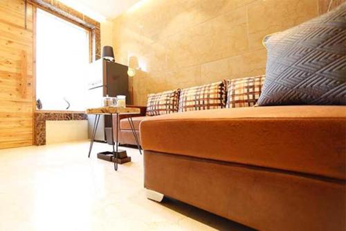 a room with a bed and a table and a window at Divine Studios Rajouri Garden in New Delhi