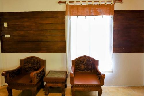 two chairs sitting in a room with a window at Ziggy Stardust in Ko Phayam