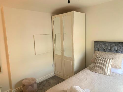 a bedroom with a bed and a white cabinet at Naas 2 Bedroom Back Garden Escape in Naas