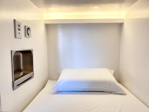 a small bedroom with a bed and a tv at Aquarela do Leme in Rio de Janeiro
