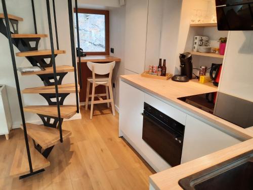 a kitchen with a counter and a stove top oven at Bulle en Ville Maisonnette de charme in Spa