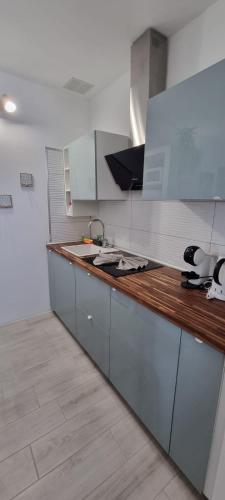 a kitchen with a sink and a wooden counter top at Monolocale Splendida casa vacanze in Tenerife del Sur Casa Mimì in Arona