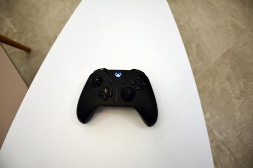 a black video game controller sitting on top of a table at City Haven Apartment in Chania Town
