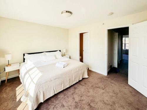 a white bedroom with a large white bed in it at Luxury Style 2 King Bed WD FREE Garage in Schenectady