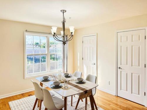 a dining room with a table and chairs and a window at Luxury Style 2 King Bed WD FREE Garage in Schenectady