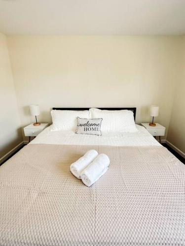 a white bed with two towels on top of it at Luxury Style 2 King Bed WD FREE Garage in Schenectady