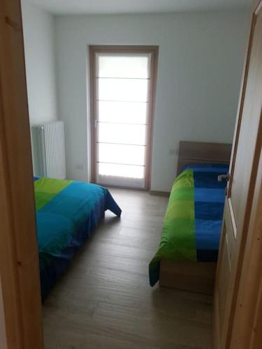 Ένα ή περισσότερα κρεβάτια σε δωμάτιο στο Bormio suite apartment, terme e sci a 5 min. di auto