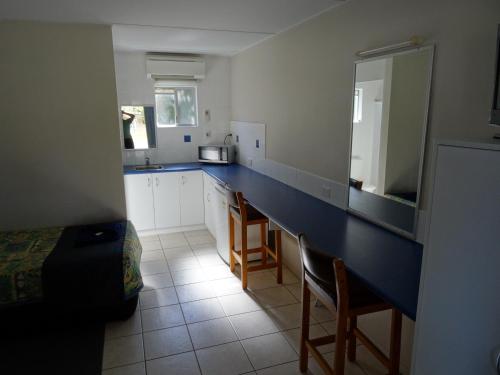 a kitchen with a blue counter top in a room at Chinderah Motel in Chinderah