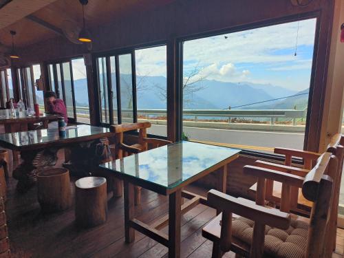 a restaurant with a table and a view of the mountains at Mo Huai Su-桃園市民宿085號 in Hualing