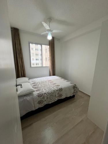 a white bedroom with a bed and a window at Apartamento Barra Funda - 202 in Sao Paulo