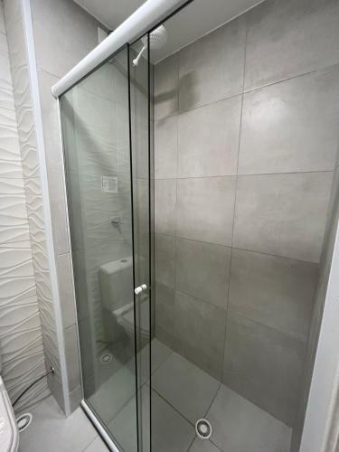a glass shower in a bathroom with a toilet at Apartamento Barra Funda - 202 in Sao Paulo
