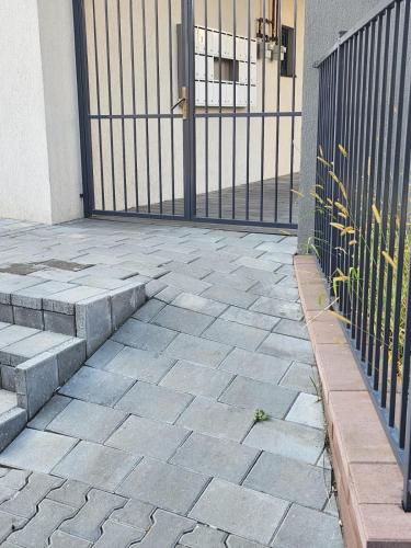 a patio with a gate and steps next to a building at Best View Terrace in Târgu-Mureş