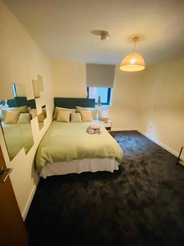 a bedroom with a large bed and a lamp at Liverpool City Centre Modern Apartment fits 6 people in Liverpool
