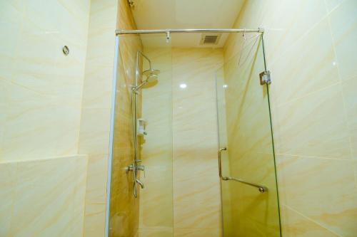 a shower with a glass door in a bathroom at Formosa Spacious Apartments with Netflix & Pick Up Service by MESA in Nagoya