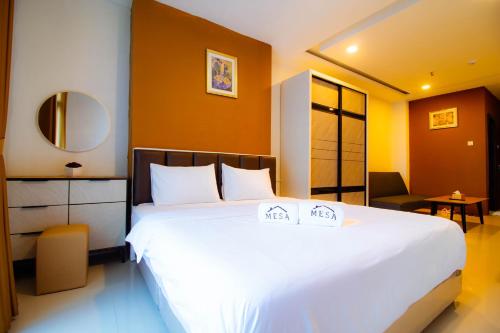 a bedroom with a large white bed and a mirror at Formosa Spacious Apartments with Netflix & Pick Up Service by MESA in Nagoya