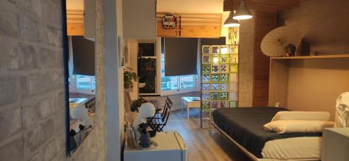 a room with a bed and a couch in a room at SALTILLO ALTO WHITE STUDIO in Torremolinos