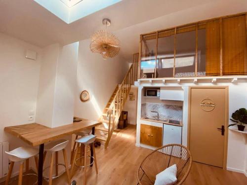 a kitchen with a table and chairs in a room at Cosy Cœur de Lille in Lille