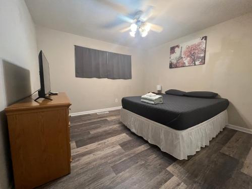 a bedroom with a bed and a flat screen tv at Quiet Munster Ranch Near Franciscan Hospital in Munster