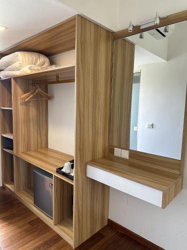 a room with wooden shelves and a mirror at Thundi Sea View in Fulidhoo
