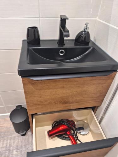 a kitchen sink with a box under it at La perle de Houlgate in Houlgate