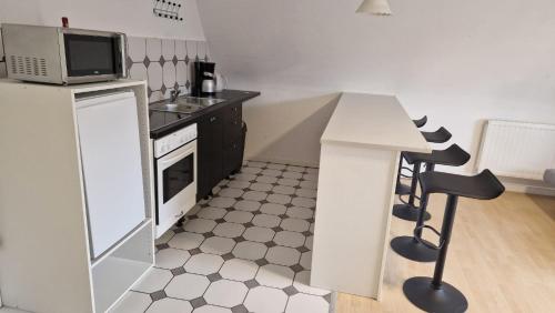 a small kitchen with a sink and a microwave at 2,5 Zimmerwohnung in Mönchengladbach