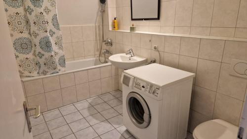a bathroom with a washing machine and a sink at 2,5 Zimmerwohnung in Mönchengladbach
