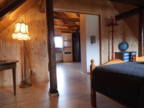 a bedroom with a bed in a room with wooden walls at Kuća za odmor Elf in Kupjak