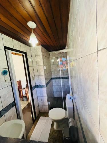 a bathroom with two toilets in a room at Pousada Novo Encanto Maresias in Maresias