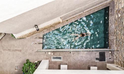 a person swimming in the water in a pool at Art Hotel Athens in Athens