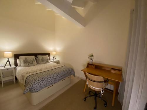 a bedroom with a bed and a desk and a desk at La Cantonada II in Bourg-Madame