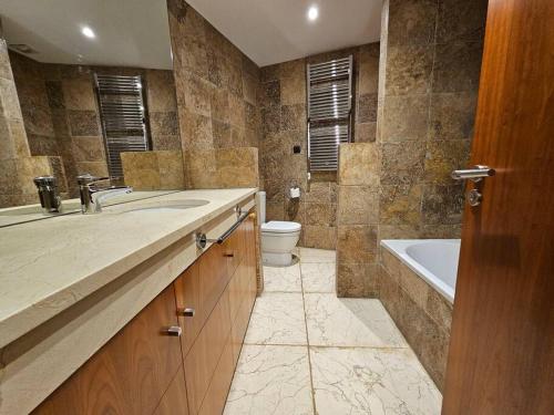 a bathroom with a sink and a tub and a toilet at Mirador La Jirafa - 638A in Oviedo