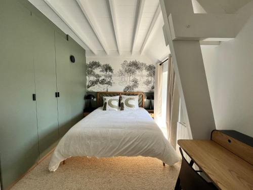 - une chambre avec un lit blanc et un plafond blanc dans l'établissement Douceur de vivre en bord de mer - Jacuzzi et cheminée, à Saint-Coulomb