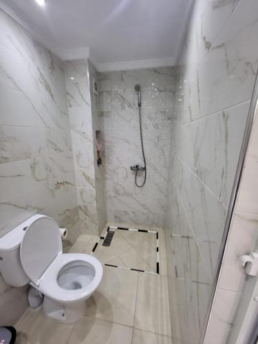 a bathroom with a toilet and a shower at Modern Studio Just Steps from the Beach in El Jadida