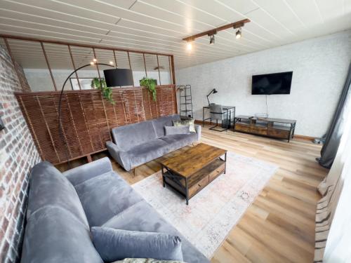 a living room with a couch and a table at FeWo Ottobeurens Schmuckstück: Gemütlich-Stylische Wohnung in Ottobeuren