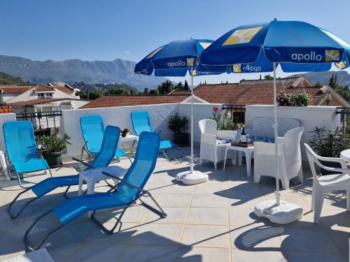 - un ensemble de chaises, de tables et de parasols sur une terrasse dans l'établissement Apartments Tamara, à Budva