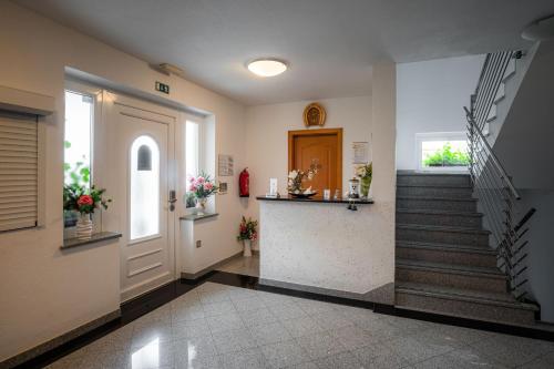 a hallway with a staircase and a stair case at Penzion Kovac in Radovljica