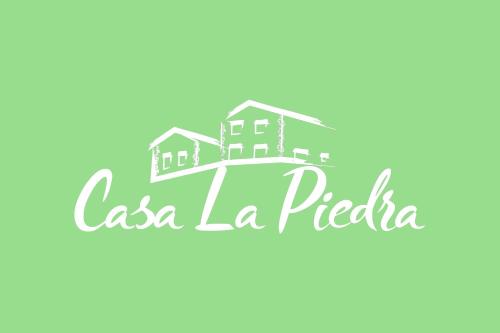 a logo for a real estate company at Apartamentos Rurales Casa la Piedra in Collía