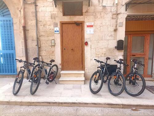 a group of bikes parked in front of a building at Guest House Albergabici La Cattedrale in Barletta