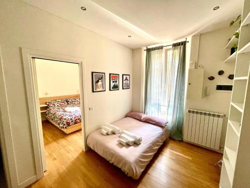 a small room with a bed and a mirror at Fiera-MiCo - Sempione Apartment in Milan