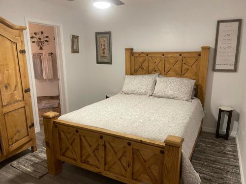 a bedroom with a large bed with a wooden headboard at Crazy Horse - APT 1 in Kanab