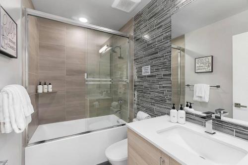 a bathroom with a tub and a sink and a toilet at Red Maple Retreat in Leschi in Seattle