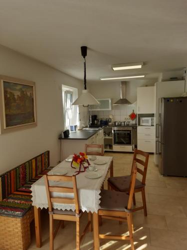 a kitchen with a table and chairs and a kitchen with a refrigerator at Ferienwohnung Dada in Oettingen in Bayern