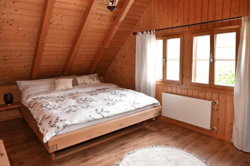 a bedroom with a bed in a wooden cabin at Ferienhaus auf dem Lamahof in Stalden
