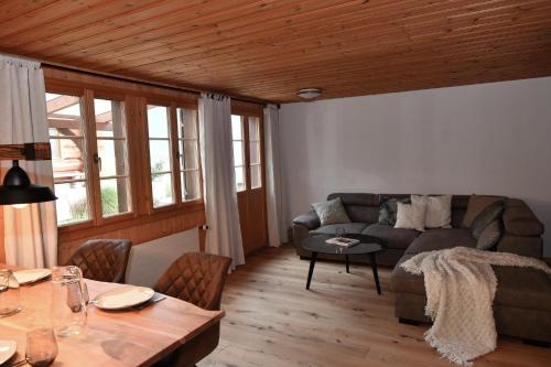 a living room with a couch and a table at Ferienhaus auf dem Lamahof in Stalden