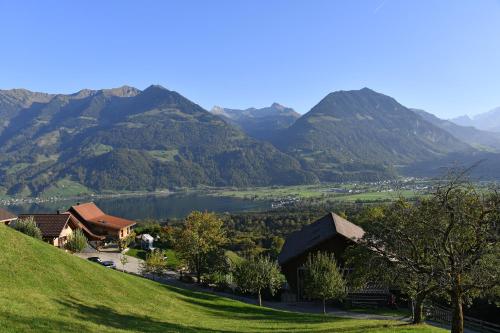 a view of a valley with a lake and mountains at Ferienhaus auf dem Lamahof in Stalden