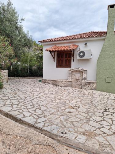 a house with a stone driveway in front of it at Villa Elea in Tseréni